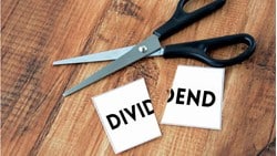scissors above a piece of paper that says "dividend"